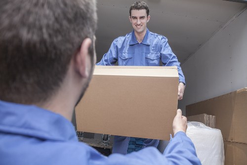 Movers sorting recyclable packing materials during a Brixton house removal