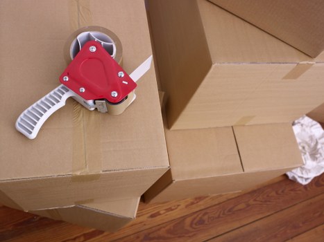 Packed household boxes and furniture ready for loading