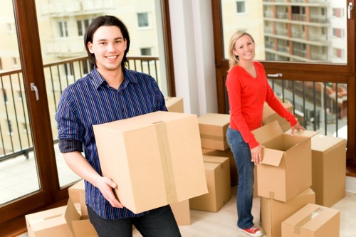 Removal team navigating stairs in a Brixton flat move