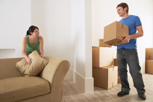 Packed boxes and furniture in a Brixton flat with narrow access